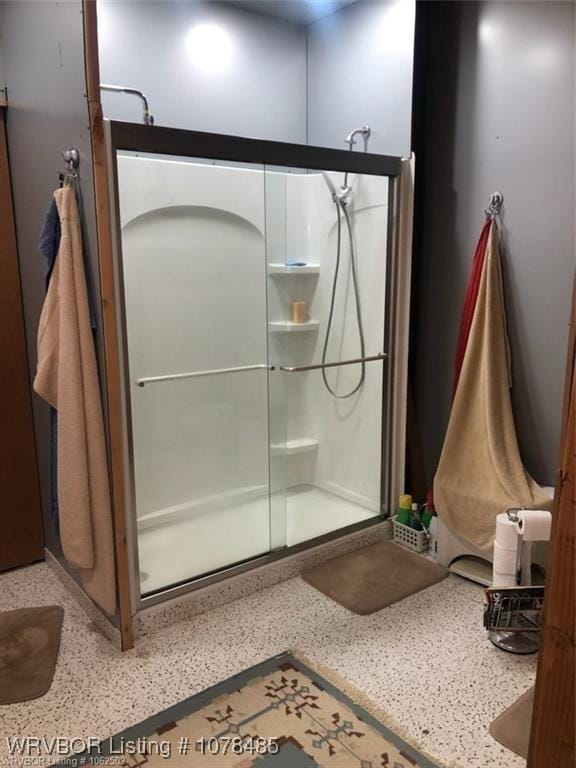 bathroom with a shower with shower door