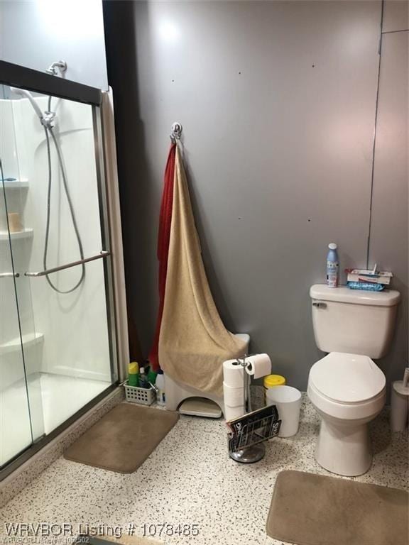 bathroom featuring walk in shower and toilet