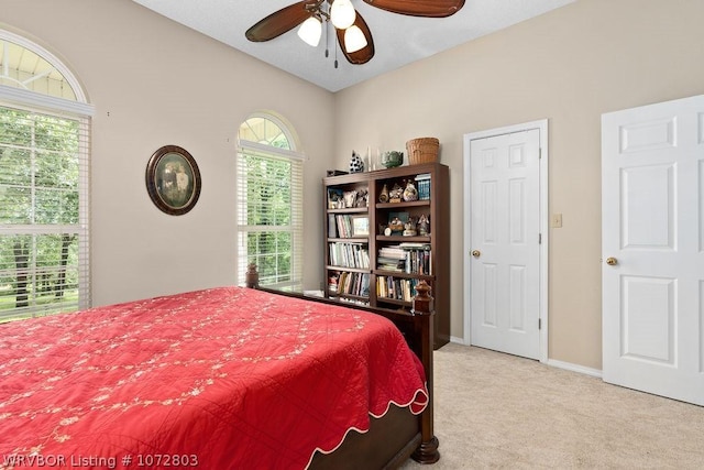 bedroom with ceiling fan and light carpet