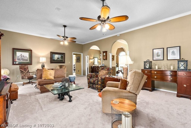 carpeted living room with a textured ceiling, ceiling fan, and ornamental molding