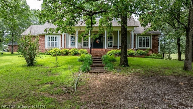 view of front of home with covered porch and a front yard