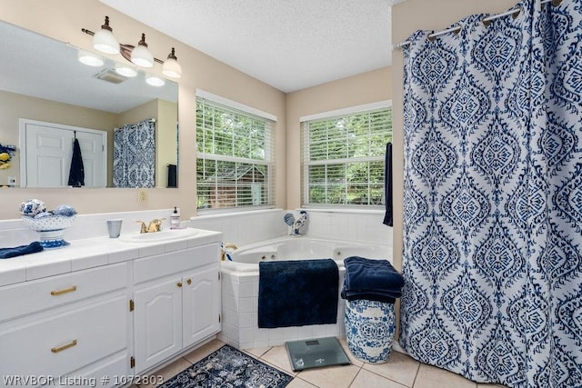 bathroom with tile patterned floors, vanity, and a textured ceiling