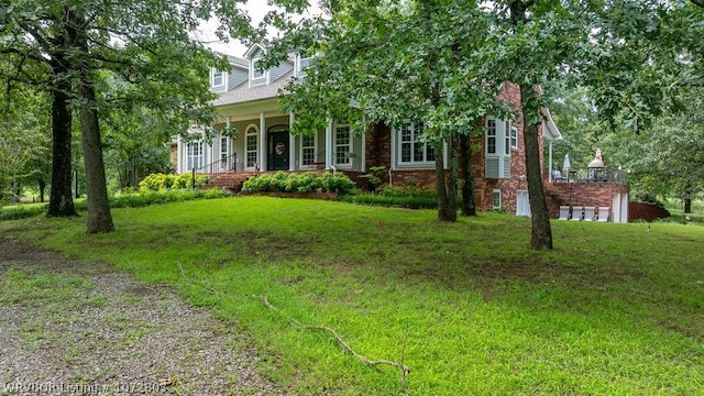 obstructed view of property with a porch and a front yard