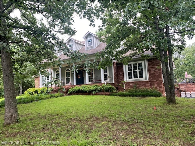 view of front facade featuring a front lawn and covered porch