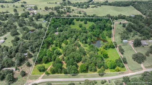 birds eye view of property featuring a rural view and a water view