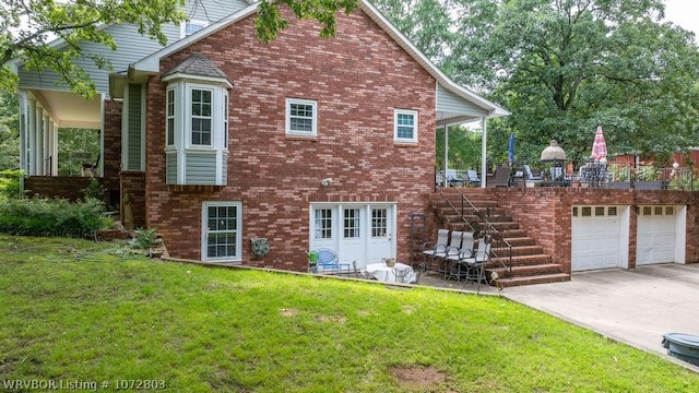 back of property featuring a yard and a garage