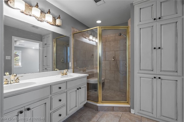 full bathroom featuring visible vents, a shower stall, tile patterned flooring, and a sink