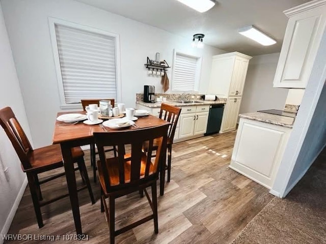 dining area with sink and light hardwood / wood-style flooring