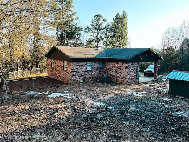 view of side of home featuring central AC and a carport