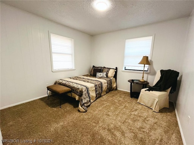 bedroom featuring a textured ceiling and carpet flooring