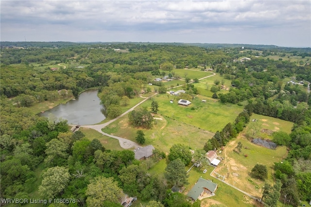 drone / aerial view featuring a wooded view and a water view