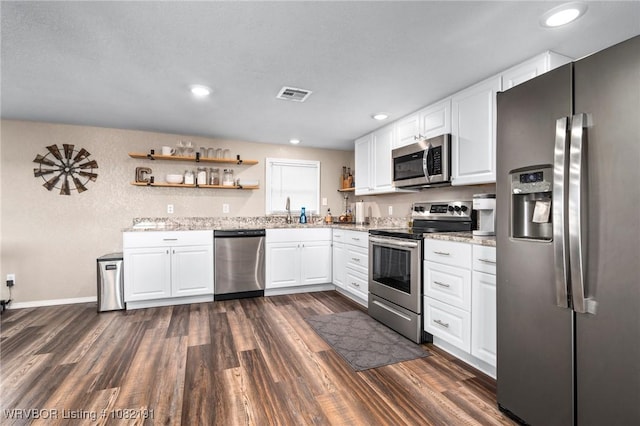 106595 S 4770th Rd, Muldrow, OK 74948 - kitchen with stainless steel appliances, open shelves, dark wood-style floors, light stone counters, and recessed lighting