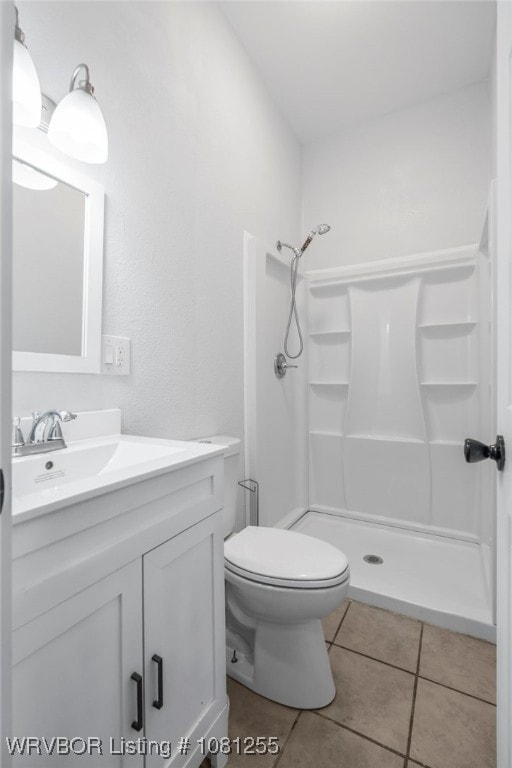 618 Sycamore St, Van Buren, AR 72956 - bathroom with a shower stall, vanity, tile patterned floors, and toilet