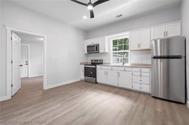 618 Sycamore St, Van Buren, AR 72956 - kitchen featuring appliances with stainless steel finishes, light wood-type flooring, white cabinets, a ceiling fan, and recessed lighting