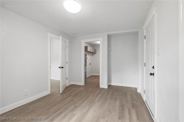 618 Sycamore St, Van Buren, AR 72956 - unfurnished bedroom featuring light wood-type flooring, baseboards, and a closet