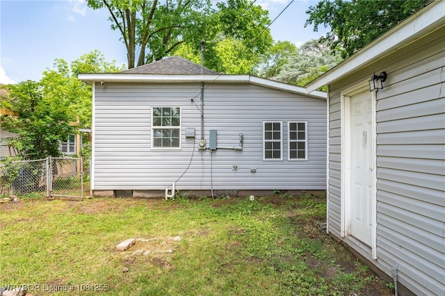 618 Sycamore St, Van Buren, AR 72956 - view of side of property with roof with shingles and a gate