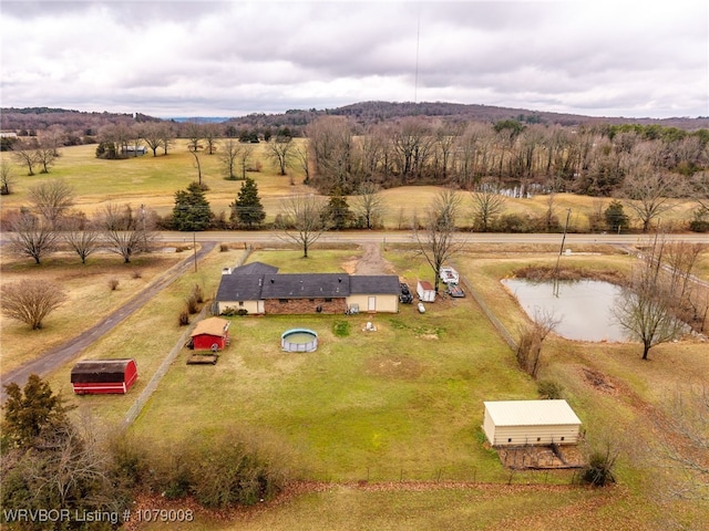 birds eye view of property featuring a water view and a rural view