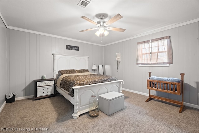 carpeted bedroom featuring crown molding and ceiling fan