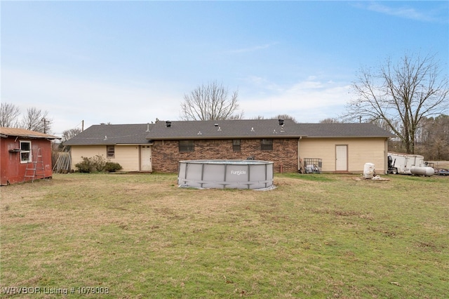 rear view of property featuring a yard