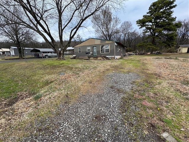 view of front facade featuring driveway and fence