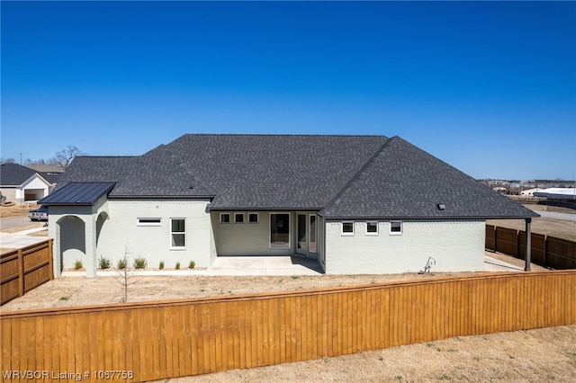 7631 Woodbine Ln, Fort Smith, AR 72916 - view of front of home featuring a fenced backyard, brick siding, a patio area, and a shingled roof