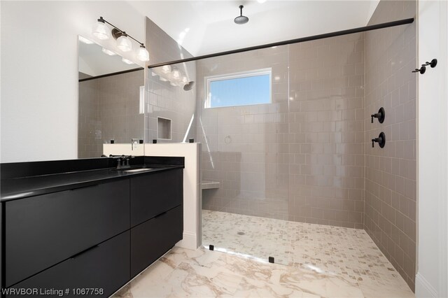 bathroom with vanity and tiled shower