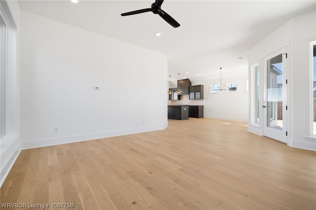 7631 Woodbine Ln, Fort Smith, AR 72916 - unfurnished living room featuring light wood finished floors, a ceiling fan, healthy amount of natural light, and recessed lighting