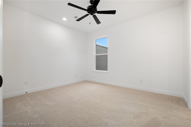 spare room with carpet and ceiling fan