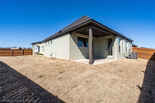 rear view of house with central AC and a patio area