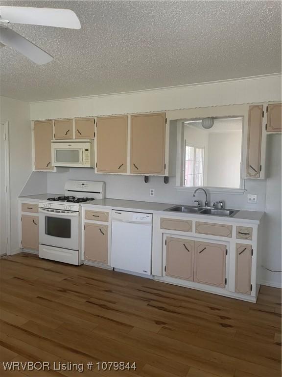 606 Highland Dr, Charleston, AR 72933 - kitchen with light countertops, a textured ceiling, a sink, and white appliances