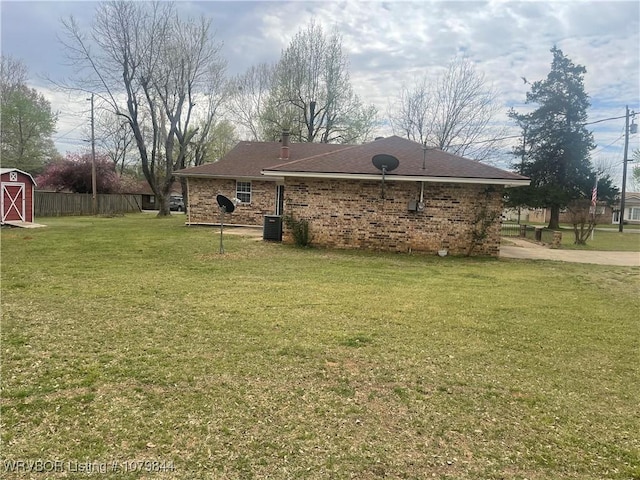 606 Highland Dr, Charleston, AR 72933 - exterior space with a lawn, an outdoor structure, fence, and brick siding
