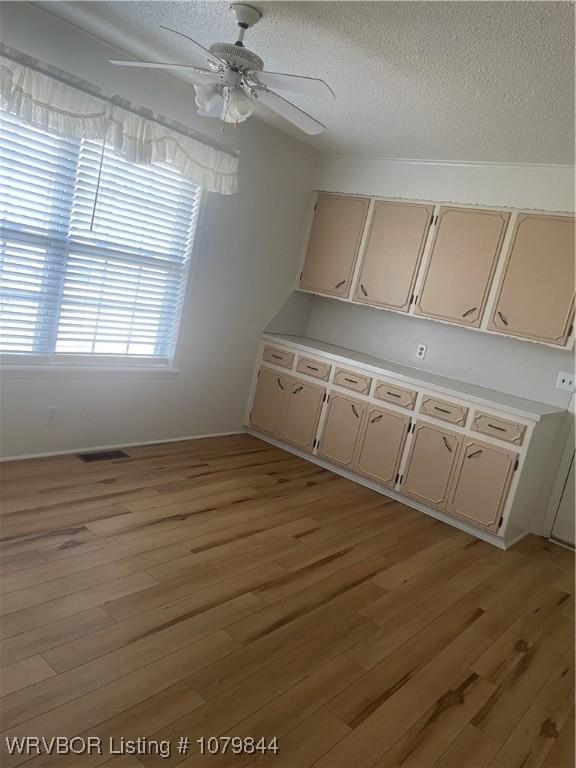606 Highland Dr, Charleston, AR 72933 - interior space with a textured ceiling, baseboards, visible vents, light wood-style floors, and ceiling fan