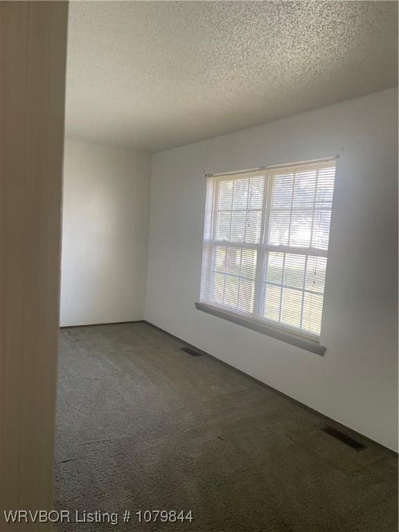 606 Highland Dr, Charleston, AR 72933 - carpeted empty room with a textured ceiling and visible vents