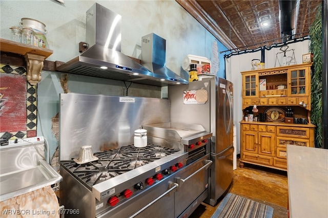 kitchen with wall chimney exhaust hood, stainless steel fridge, and concrete floors