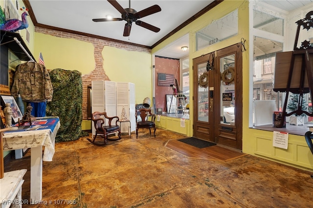 entryway featuring ceiling fan, crown molding, and brick wall