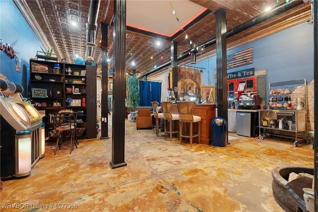 interior space featuring bar and brick ceiling