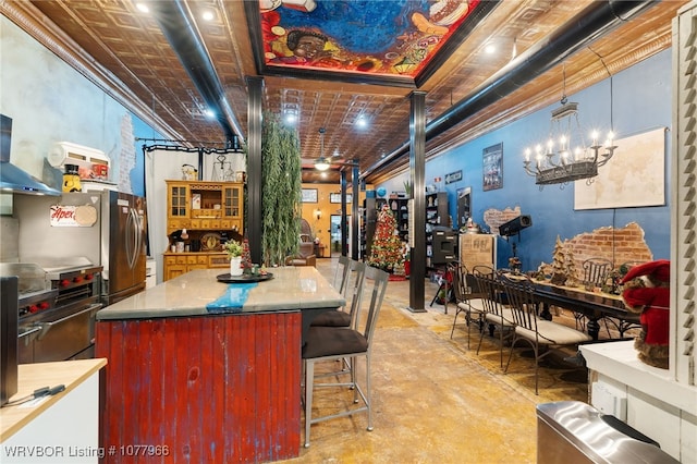 kitchen featuring high end stove, pendant lighting, a center island, and a chandelier