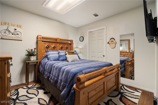 bedroom with hardwood / wood-style floors