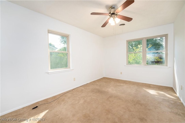 spare room featuring carpet floors and ceiling fan