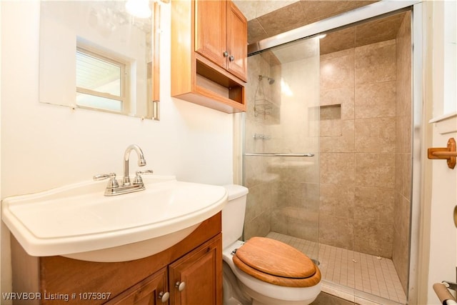 bathroom featuring vanity, toilet, and walk in shower