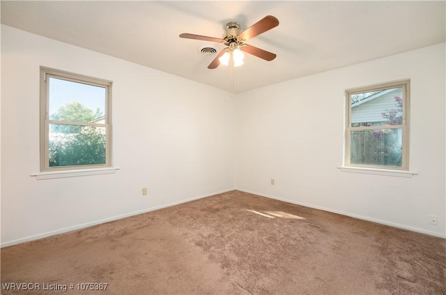 spare room featuring carpet floors and ceiling fan