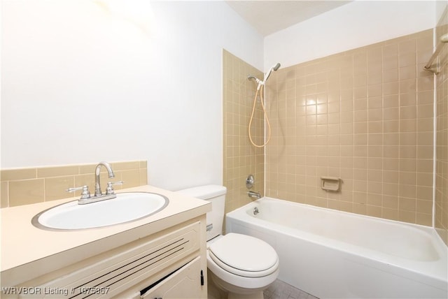 full bathroom featuring vanity, toilet, and tiled shower / bath