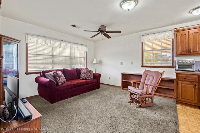 living room featuring light parquet flooring and ceiling fan