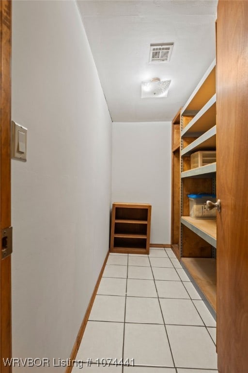 spacious closet with light tile patterned floors