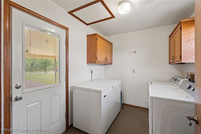 laundry room featuring washer and dryer, light tile patterned floors, and cabinets