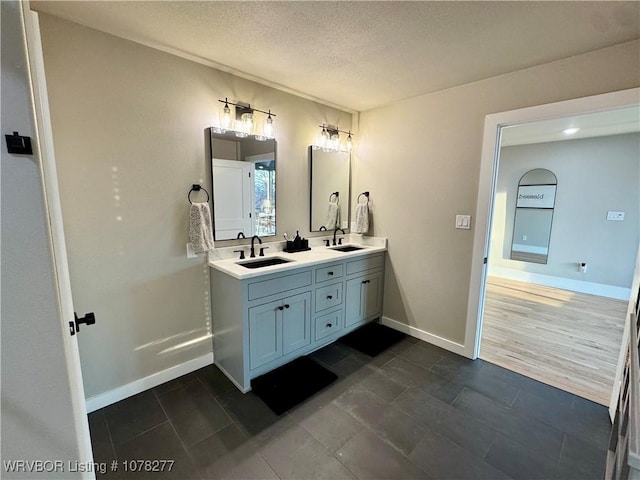 bathroom featuring vanity and a textured ceiling