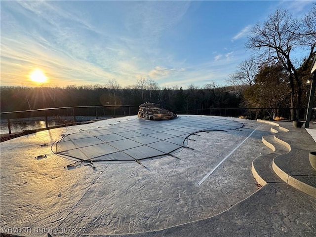 view of pool at dusk