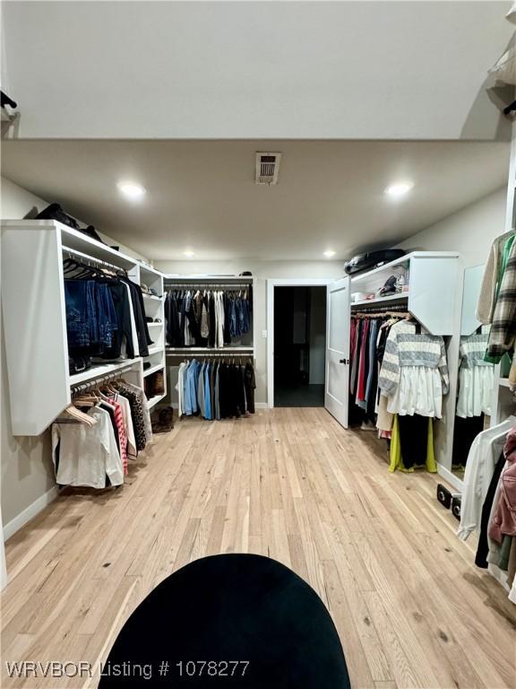 spacious closet featuring light hardwood / wood-style floors