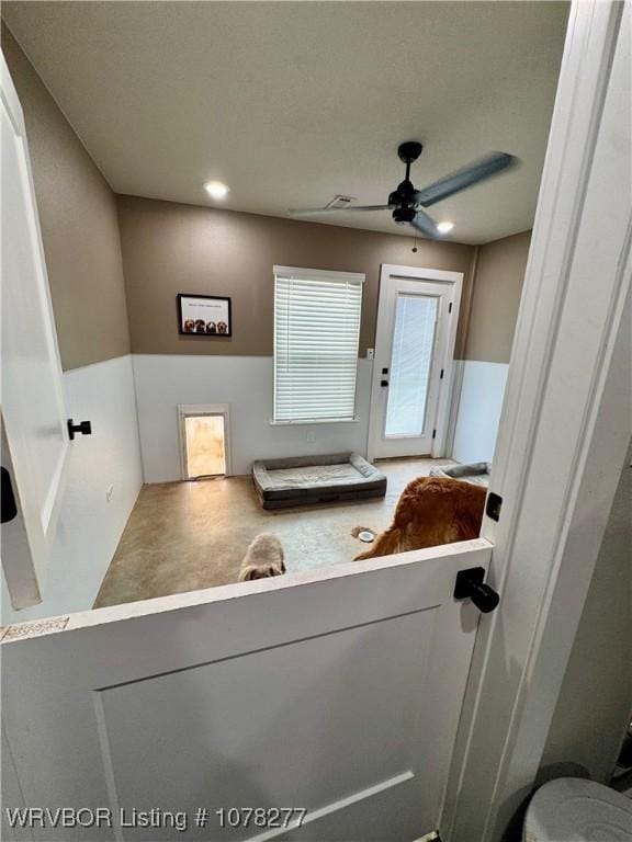 interior space featuring ceiling fan