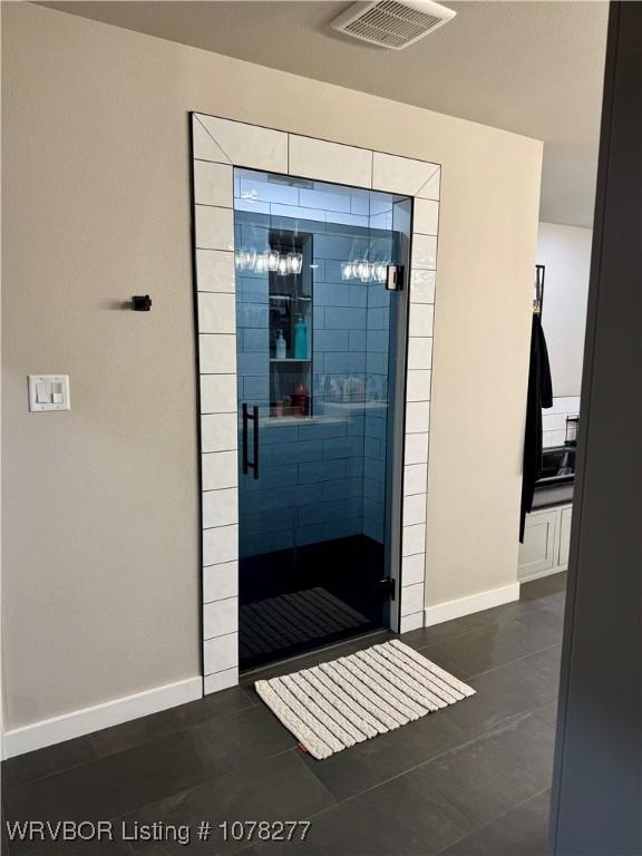 doorway with dark tile patterned floors